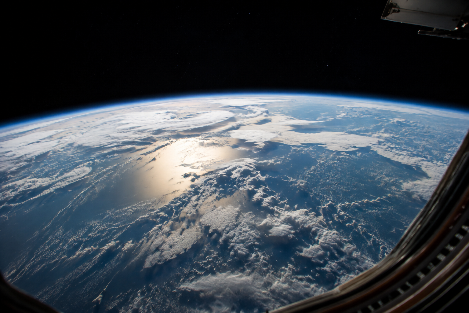 宇宙ステーションの窓から見た、青い地球と大気の層